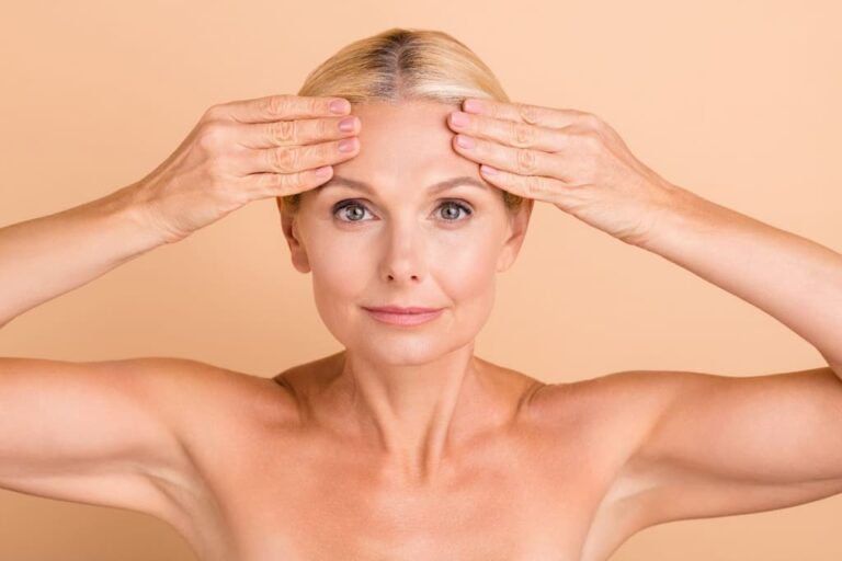 Woman placing both hands on forehead demonstrating forehead lines and expression movements that Botox treats for brow lifting and wrinkle smoothing