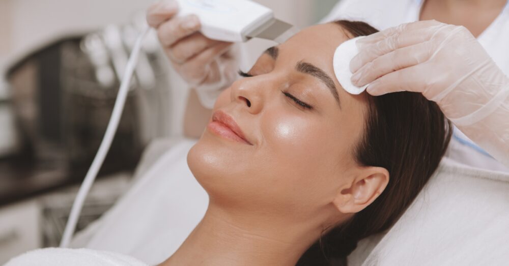 Woman receiving a facial to achieve radiant and glowing skin