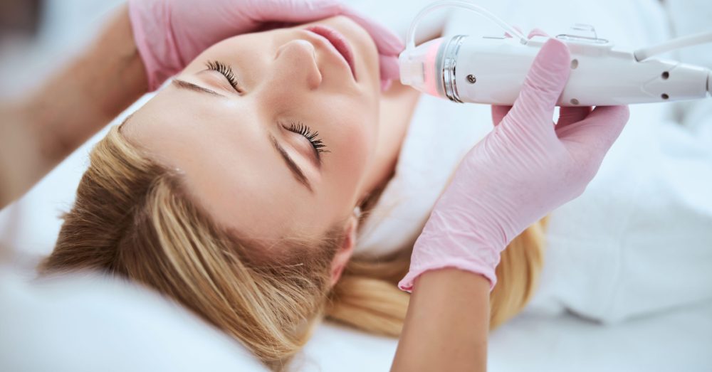 Woman receiving skin tightening treatments along her jaw
